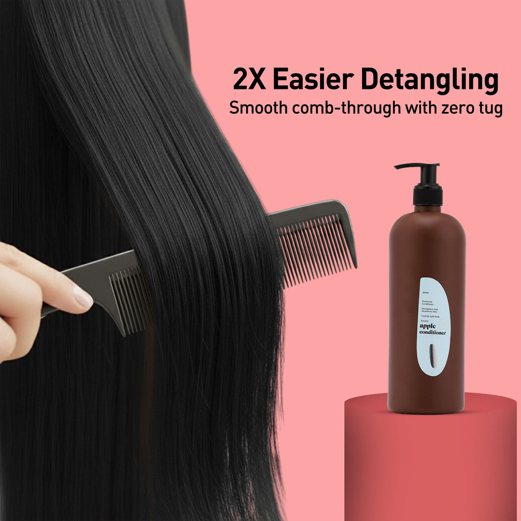 Person detangling hair with a comb, next to a bottle of shampoo on a pink background