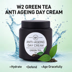 W2 Green Tea Anti-Ageing Day Cream jar with green tea leaves and water splash on a light green background