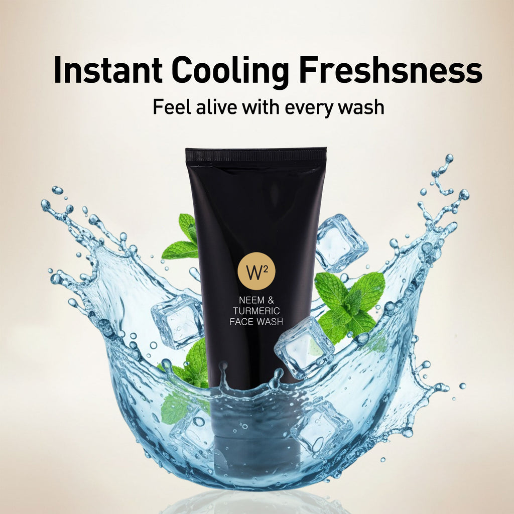 Black face wash tube with water splashes and mint leaves on a beige background