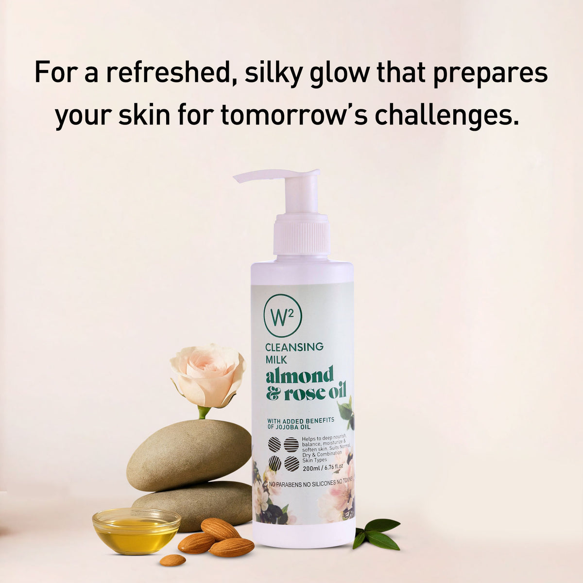 Cleansing milk bottle with almond and rose oil on a light background