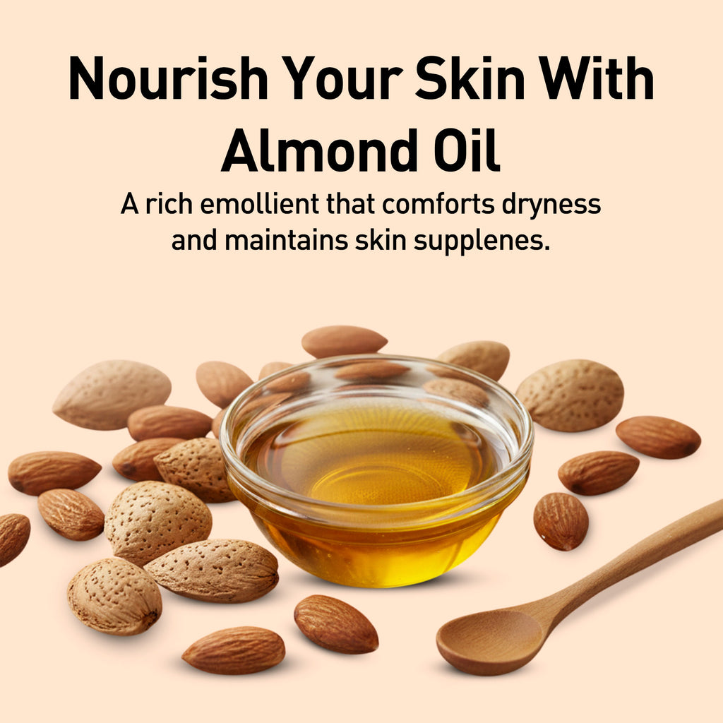 Almond oil in a glass bowl with almonds and a wooden spoon on a beige background.