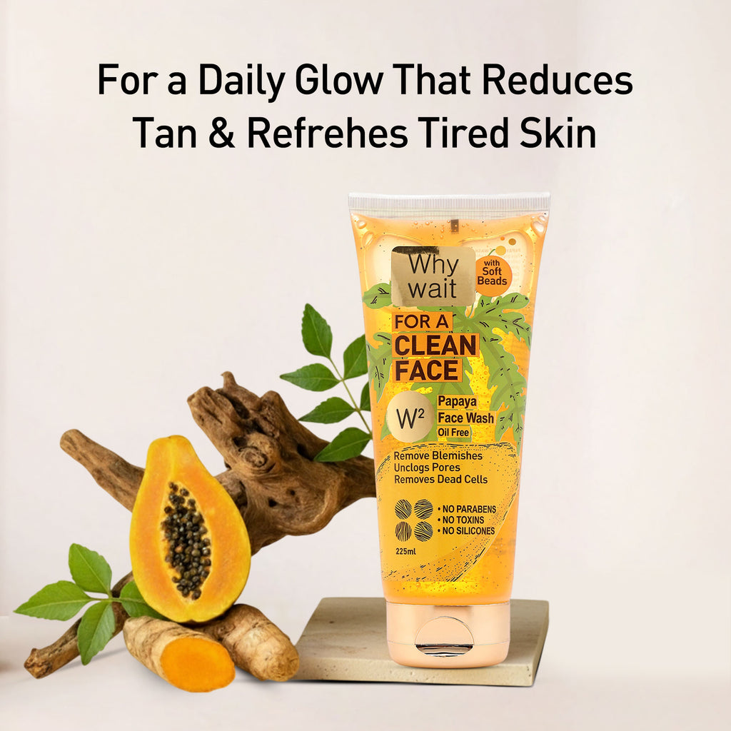 Papaya face wash tube with papaya fruit and leaves on a light background