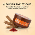 Brown jar of massage cream with saffron and wood on a beige background, promoting clear skin care.