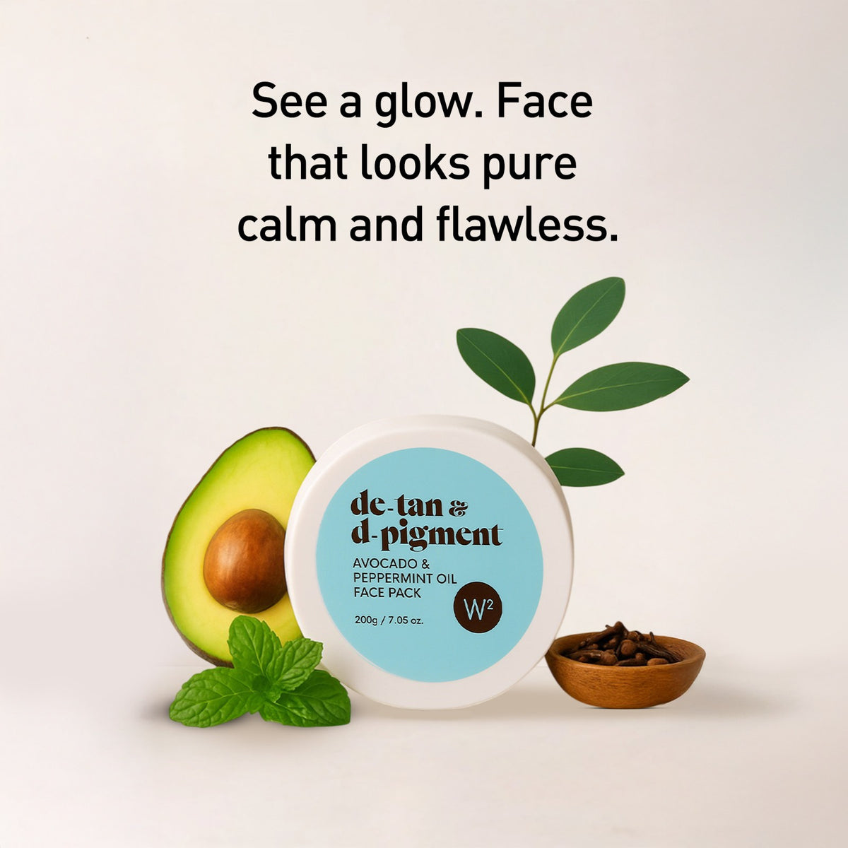 Facial product with avocado, peppermint leaves, and a small bowl on a light background